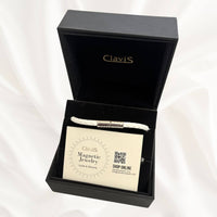 Clavis magnetic jewelry in a black box showcasing a lightweight necklace and care instructions.