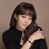 Woman wearing Clavis Hero High Power Gauss Magnetic Therapy Necklace and bracelet, promoting wellness and pain relief