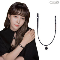 Woman wearing Clavis magnetic therapy necklace and bracelet set for wellness and energy recovery, featuring elegant design.