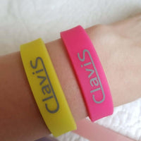 Hot pink and yellow Clavis magnetic therapy bracelets for golf, sport performance, and energy recovery.