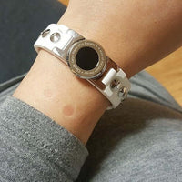 White Clavis magnetic golf bracelet on wrist, sport performance band for energy recovery, Korean wellness accessory.