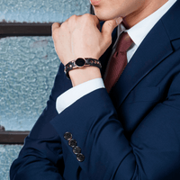 Onyx High Power Gauss Magnetic Therapy Bracelet on wrist of man in suit, ideal for magnetic golf bracelet and energy recovery.