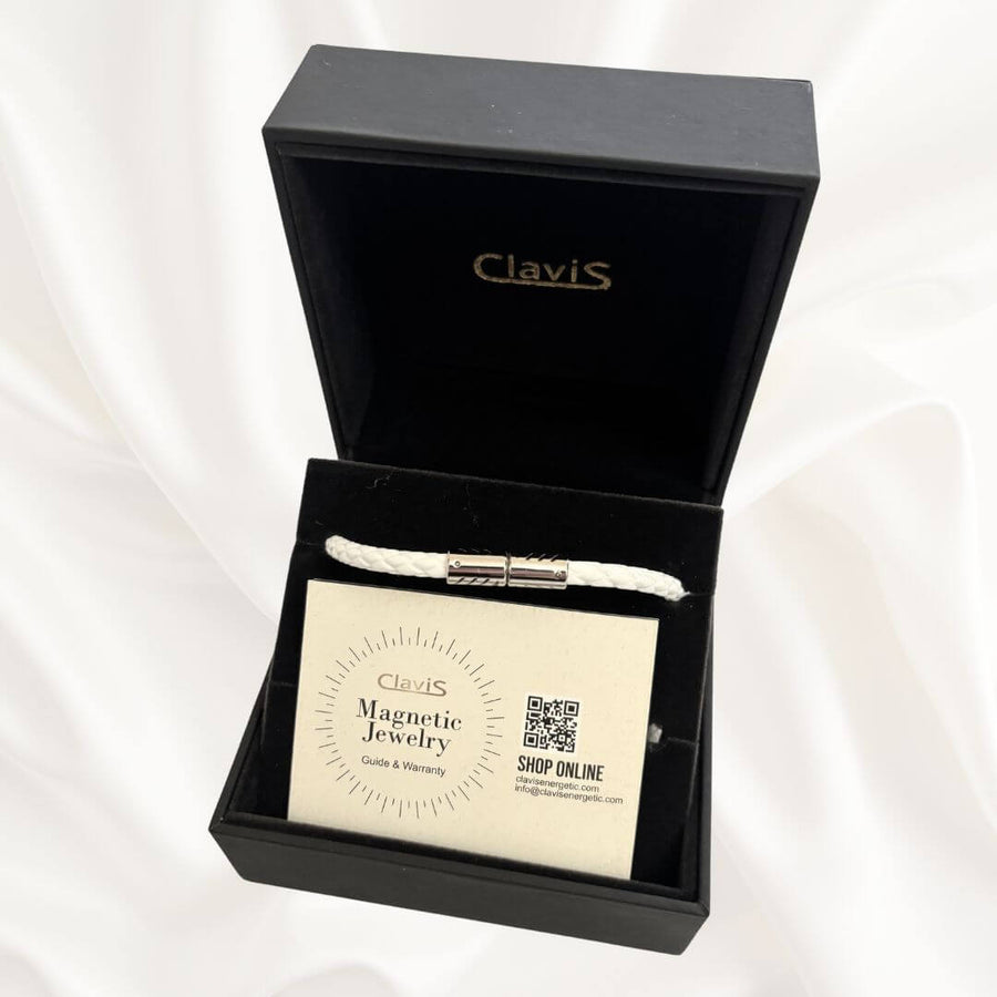 Clavis magnetic jewelry in a black box showcasing a lightweight necklace and care instructions.