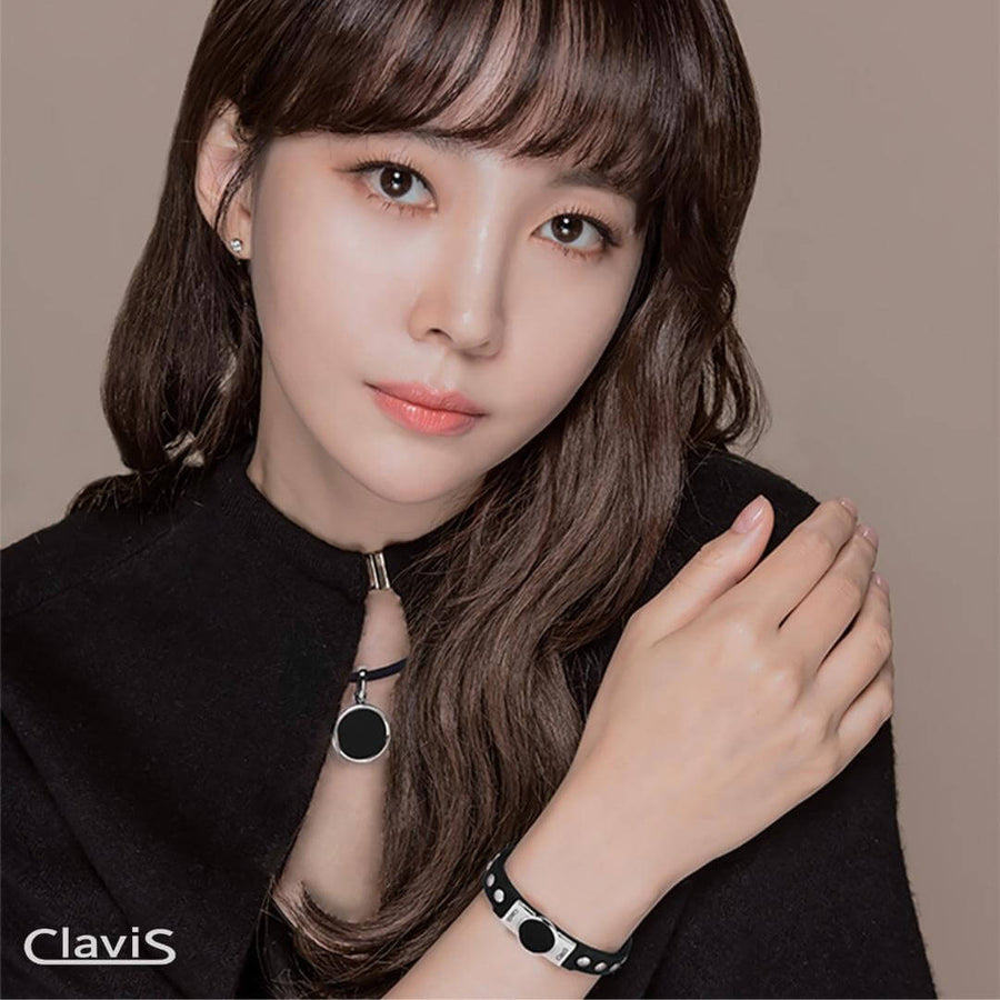 Woman wearing Clavis Hero High Power Gauss Magnetic Therapy Bracelet for athletes, promoting wellness and pain relief.