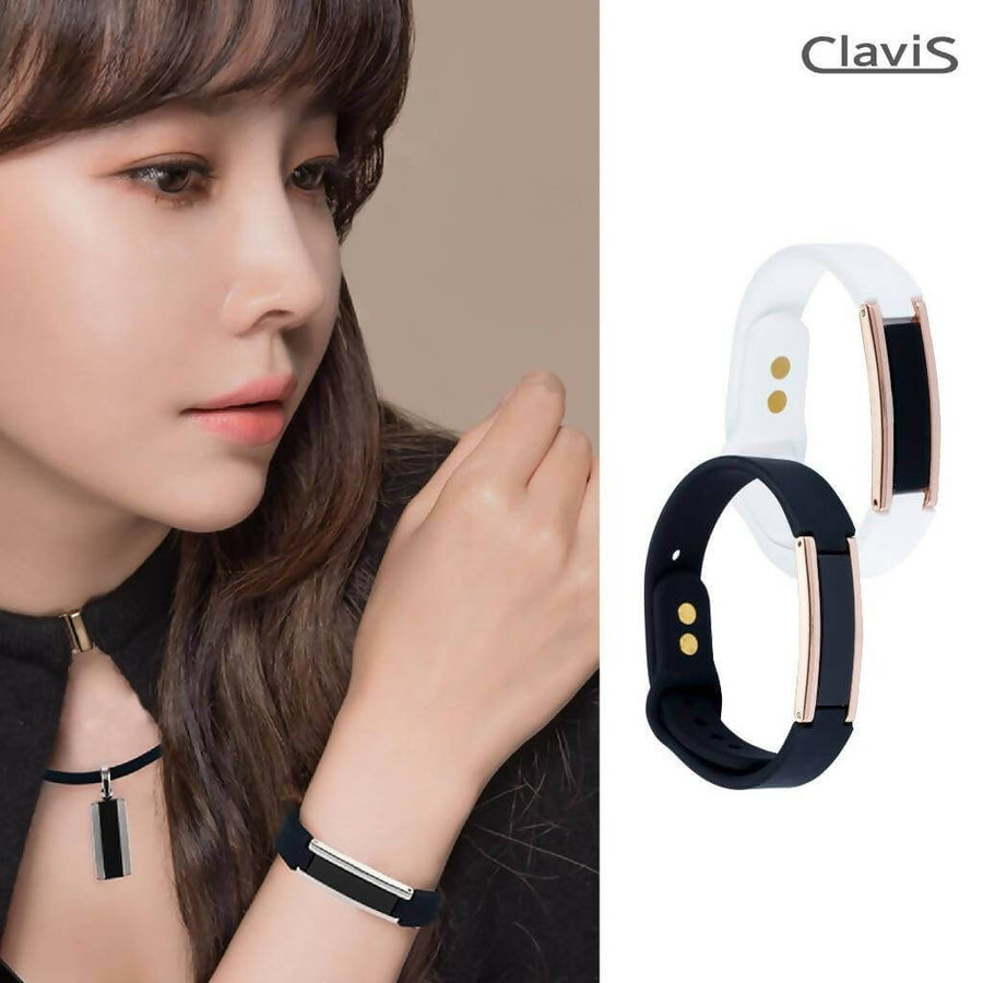 Fashionable woman wearing Clavis magnetic therapy bracelets in black and white, promoting athletic performance and energy recovery.