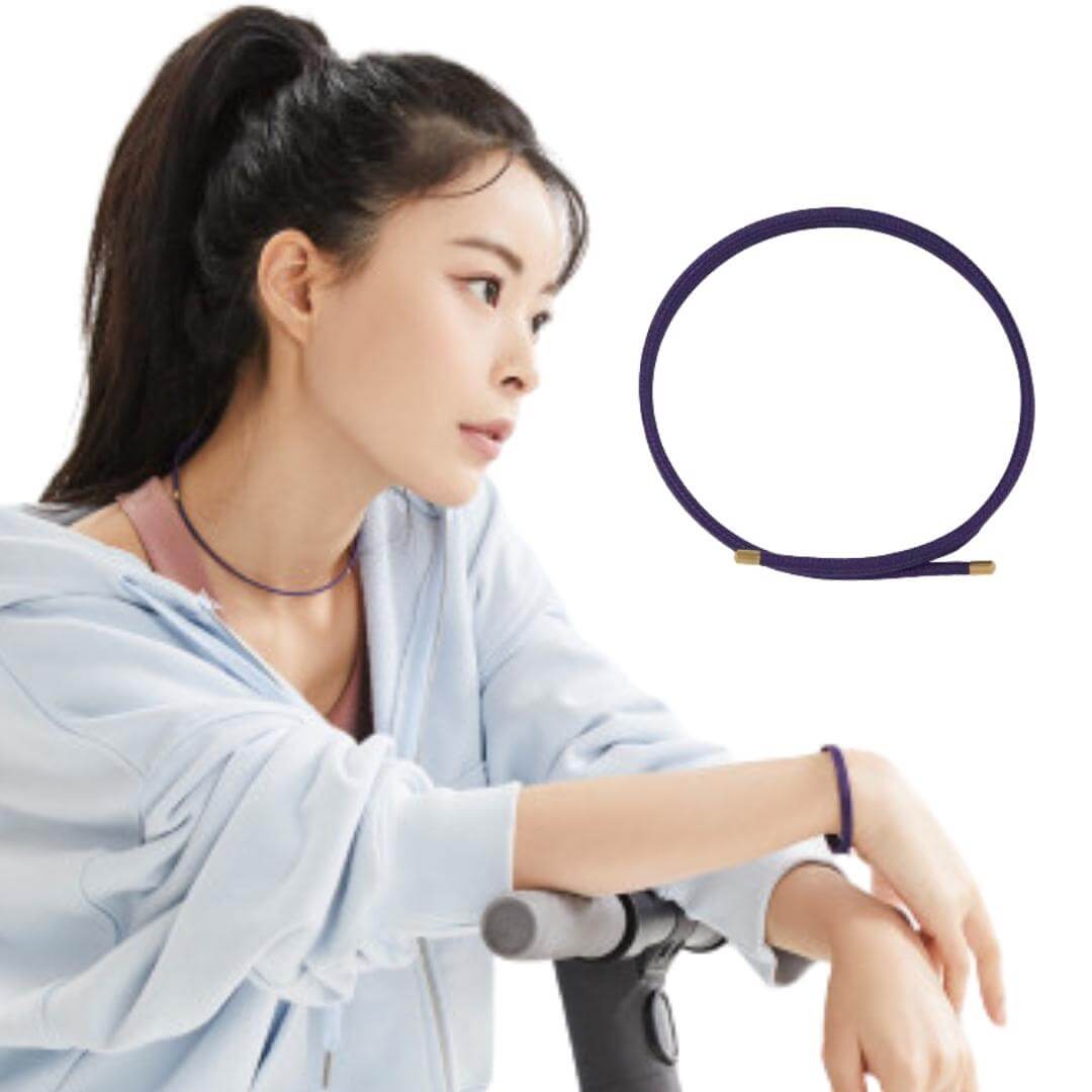 Woman wearing Luna FlexMag sports wrap bracelet in brown, showcasing its stylish magnetic therapy benefits for athletes.