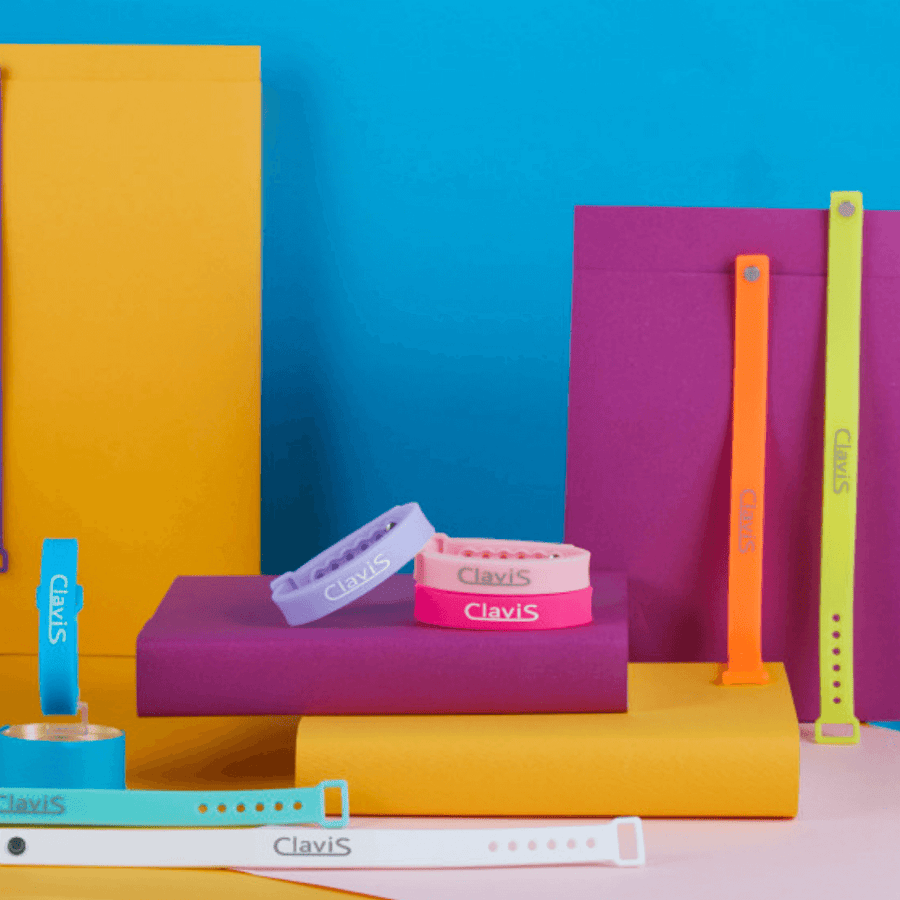 Colorful Clavis athletic edition bracelets for energy balance and magnetic therapy against a vibrant background.