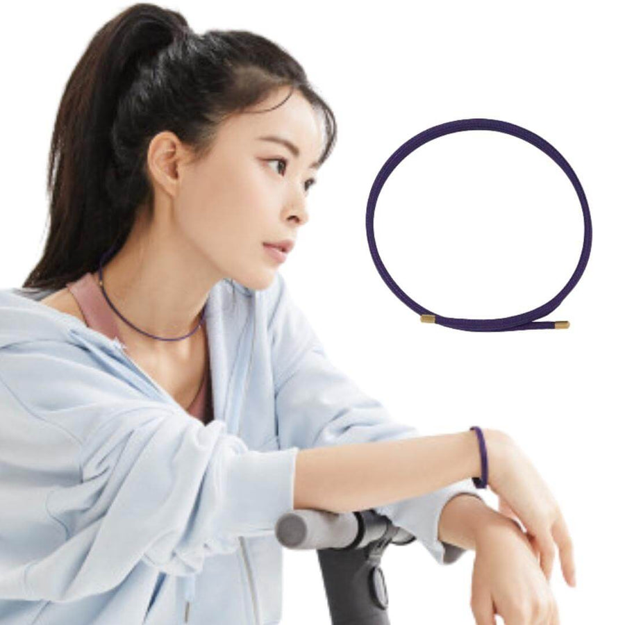 Woman wearing Luna FlexMag Magnetic Therapy Bracelet in black, featuring layered design for sports enthusiasts.