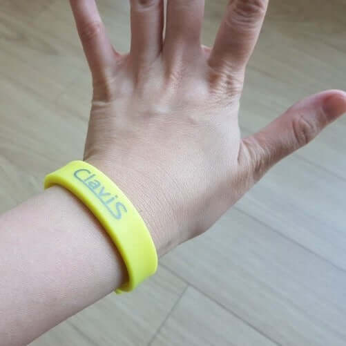 Neon yellow Clavis athletic energy bracelet for sports performance and magnetic therapy benefits.