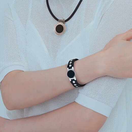 Woman wearing Onyx High Power Magnetic Therapy Bracelet for sports recovery and wellness.